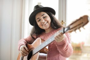 Composition & Songwriting, Female Student with Acoustic Guitar