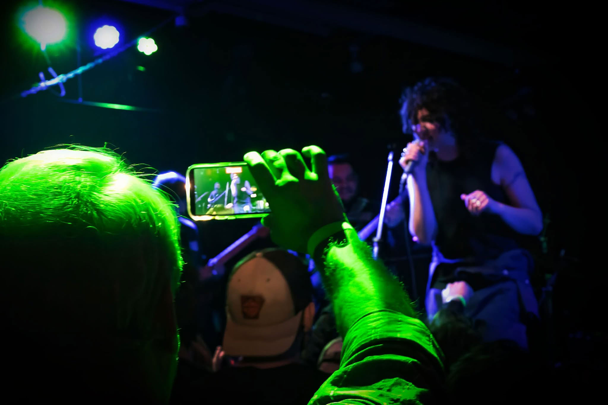 Artist manager videoing artist on stage